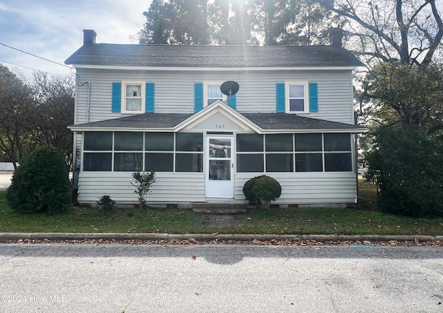 view of front facade with a sunroom