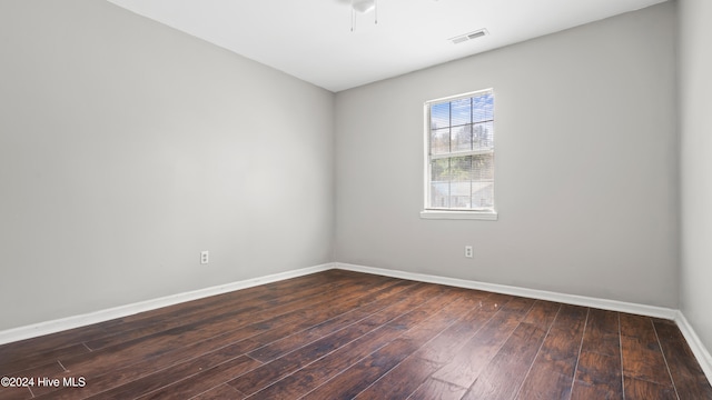 spare room with ceiling fan and dark hardwood / wood-style floors