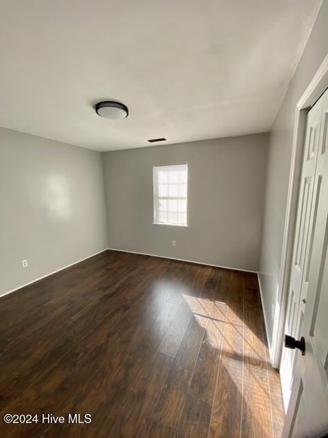 unfurnished bedroom featuring hardwood / wood-style flooring