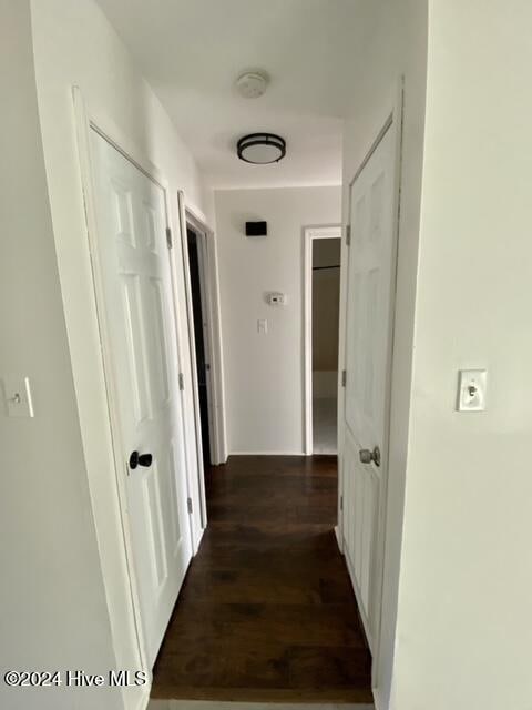 corridor with dark wood-type flooring