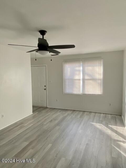 spare room with wood-type flooring and ceiling fan