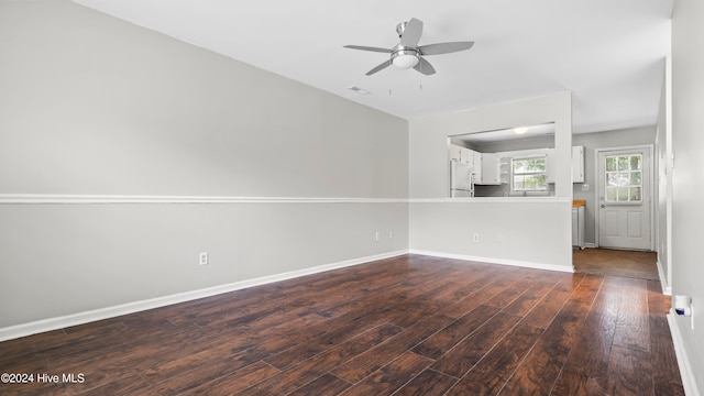 unfurnished living room featuring dark hardwood / wood-style floors and ceiling fan