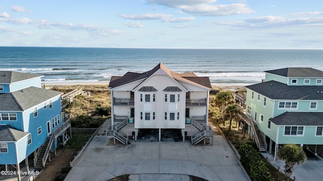 birds eye view of property featuring a view of the beach and a water view