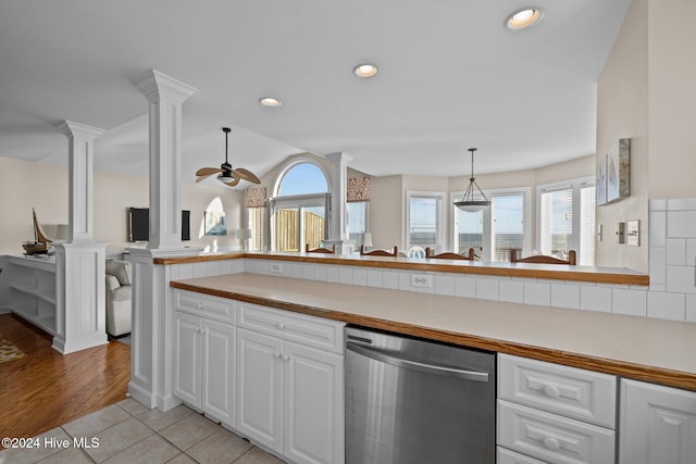 kitchen featuring stainless steel dishwasher, a wealth of natural light, ceiling fan, and white cabinets