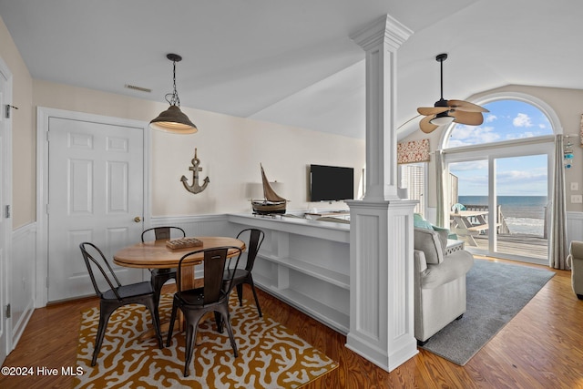 dining area featuring decorative columns, lofted ceiling, hardwood / wood-style flooring, and ceiling fan