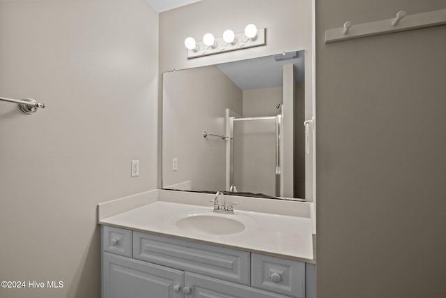 bathroom with an enclosed shower and vanity