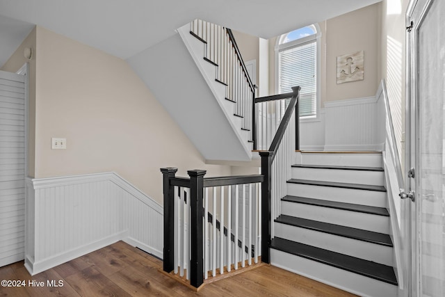 staircase with wood-type flooring