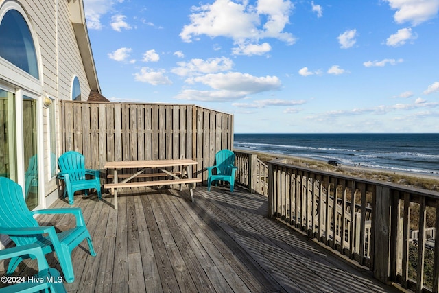 deck with a beach view and a water view