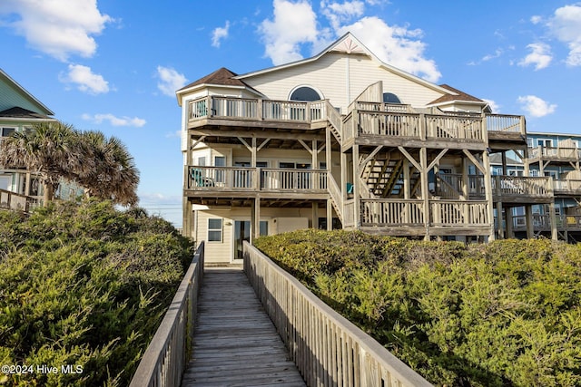 rear view of property featuring a deck