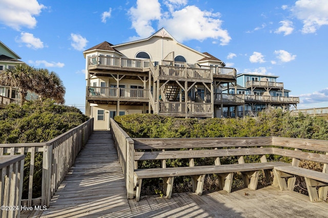 rear view of house featuring a wooden deck