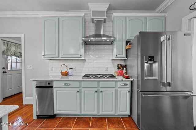 kitchen featuring appliances with stainless steel finishes, wall chimney exhaust hood, dark hardwood / wood-style floors, backsplash, and crown molding