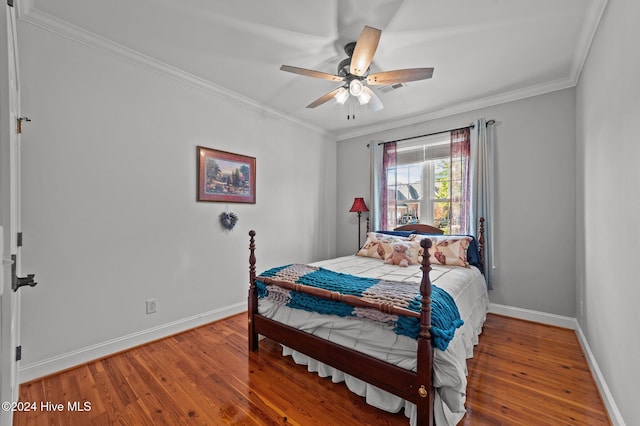 bedroom featuring wood-type flooring, ceiling fan, and crown molding