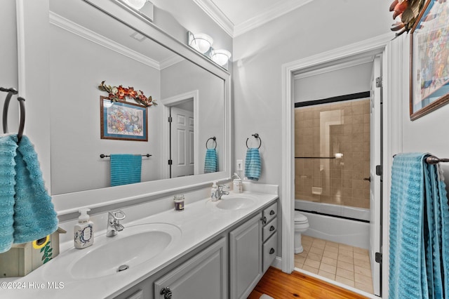 full bathroom with toilet, hardwood / wood-style floors, ornamental molding, shower / bath combination with glass door, and vanity