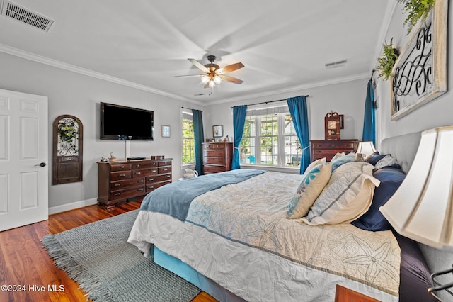 bedroom with hardwood / wood-style flooring, ceiling fan, and crown molding