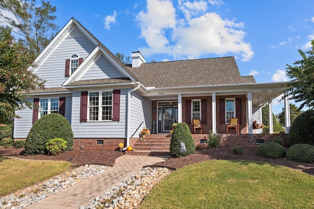 view of front of property with covered porch and a front lawn