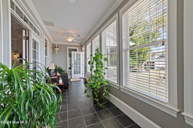 sunroom / solarium featuring a wealth of natural light and ceiling fan