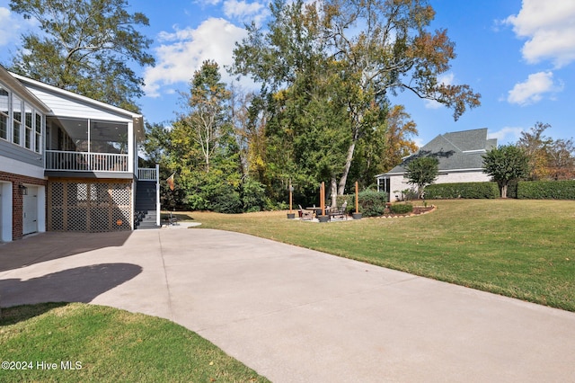 view of yard with a sunroom and a garage