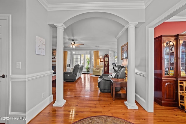 foyer entrance with ornamental molding, hardwood / wood-style floors, and ceiling fan