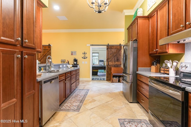 kitchen with sink, crown molding, a barn door, and appliances with stainless steel finishes