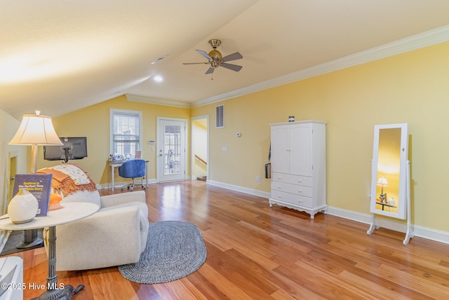 living area with crown molding, vaulted ceiling, light hardwood / wood-style floors, and ceiling fan