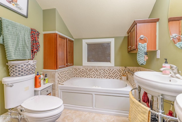 bathroom featuring tile patterned floors, a tub to relax in, toilet, vaulted ceiling, and a textured ceiling