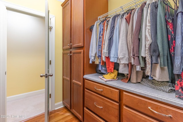 spacious closet featuring light hardwood / wood-style floors