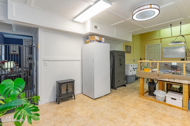 interior space featuring white refrigerator and a wood stove