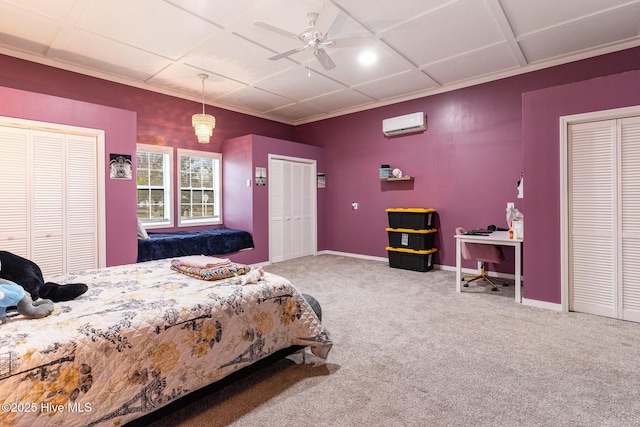 bedroom with multiple closets, an AC wall unit, carpet floors, and ceiling fan