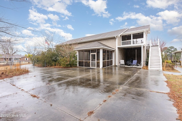 back of house featuring a sunroom