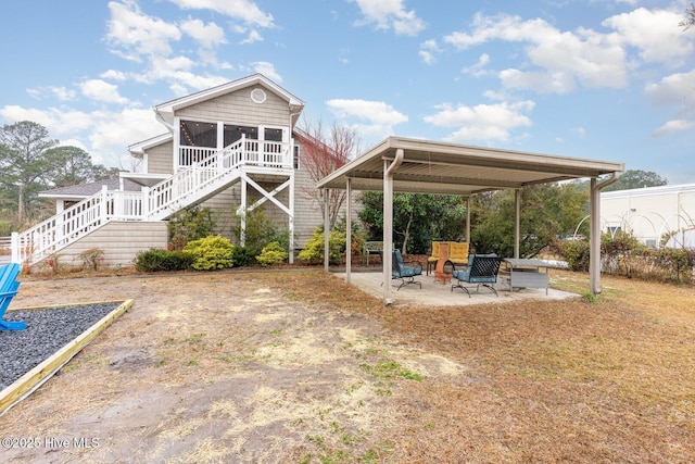 back of property featuring a patio and a sunroom