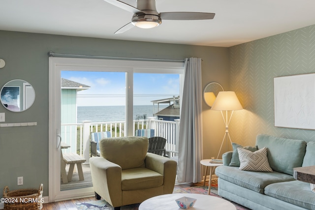 living room featuring a water view, ceiling fan, and wood-type flooring