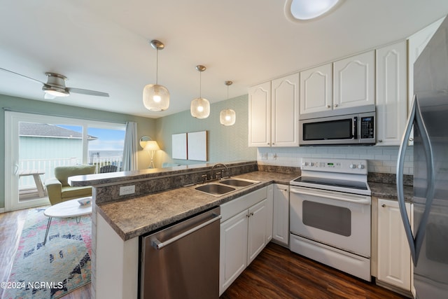 kitchen featuring white cabinets, kitchen peninsula, stainless steel appliances, and sink