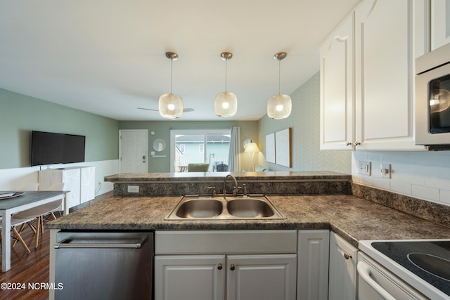 kitchen with white cabinets, dark hardwood / wood-style floors, sink, and appliances with stainless steel finishes