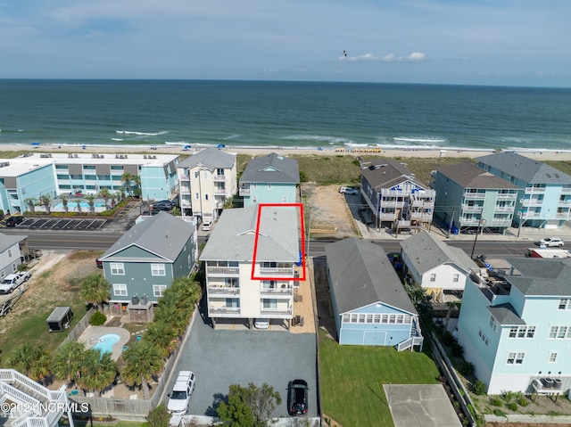 drone / aerial view featuring a beach view and a water view