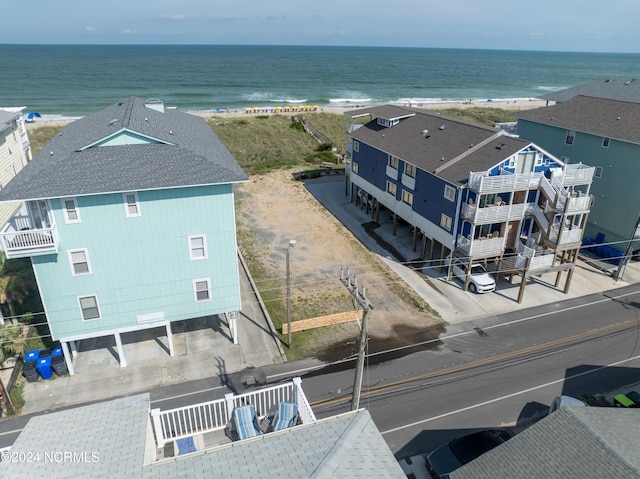 drone / aerial view featuring a water view and a view of the beach