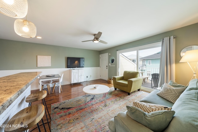 living room featuring hardwood / wood-style flooring and ceiling fan