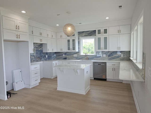 109 Old Village Ln, North Topsail Beach, NC 28460 - kitchen featuring stainless steel dishwasher, light wood-type flooring, white cabinets, tasteful backsplash, and recessed lighting