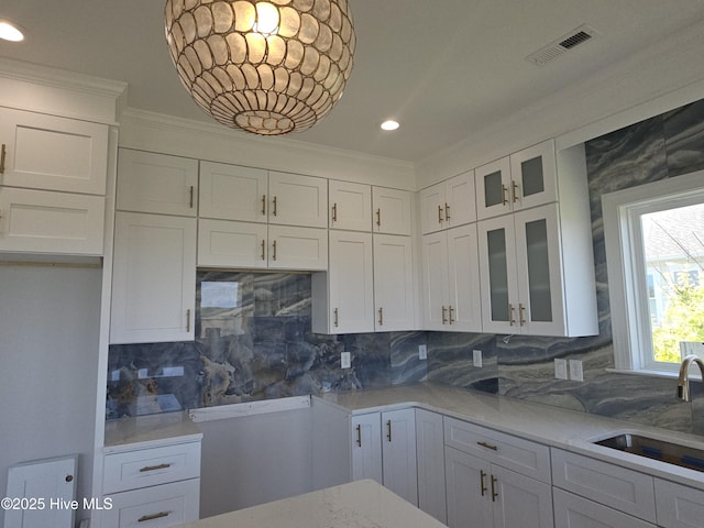 109 Old Village Ln, North Topsail Beach, NC 28460 - kitchen with a sink, crown molding, white cabinets, backsplash, and glass insert cabinets