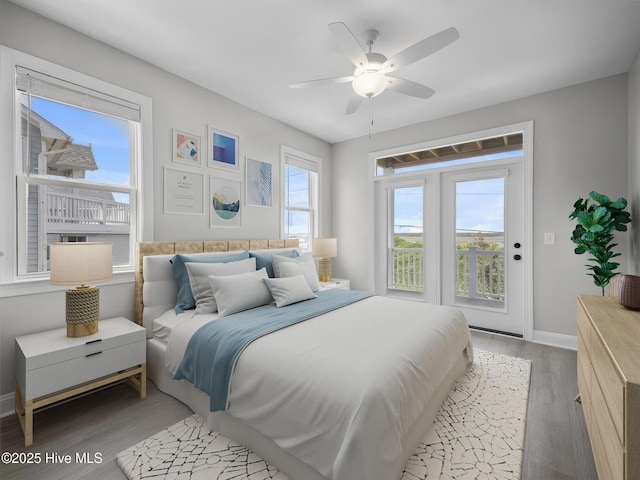 bedroom with light wood-type flooring, access to outside, baseboards, and a ceiling fan