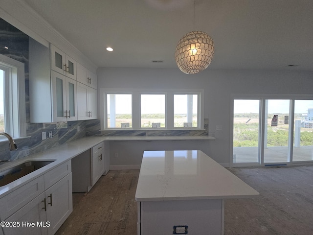 109 Old Village Ln, North Topsail Beach, NC 28460 - kitchen with a sink, white cabinets, a center island, backsplash, and recessed lighting