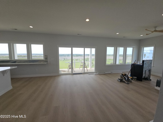 109 Old Village Ln, North Topsail Beach, NC 28460 - unfurnished living room featuring plenty of natural light, recessed lighting, baseboards, wood finished floors, and ceiling fan