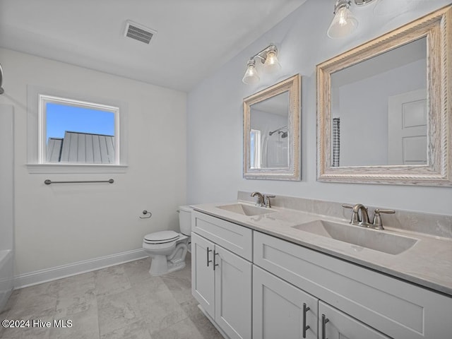 bathroom with walk in shower, vanity, and toilet