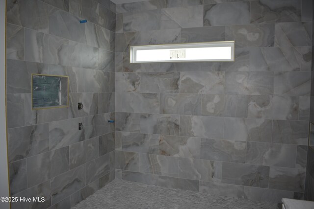 bathroom with tiled shower / bath combo and vanity