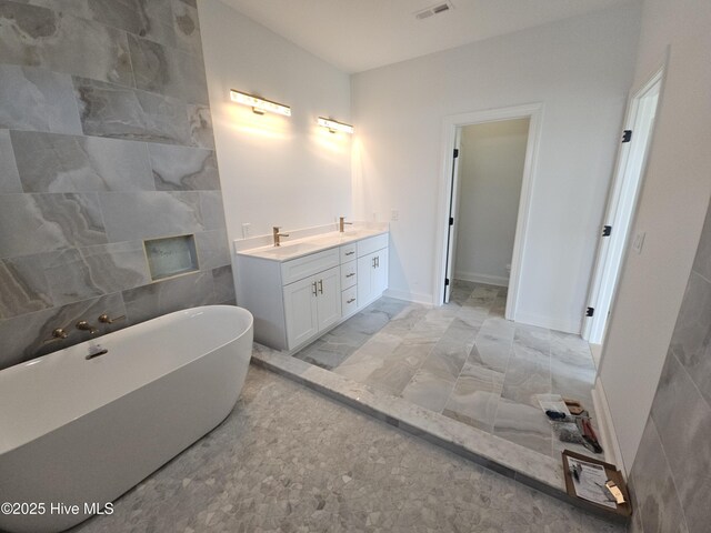 109 Old Village Ln, North Topsail Beach, NC 28460 - bathroom featuring a freestanding tub, double vanity, and marble finish floors