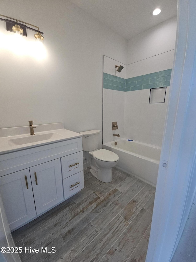 109 Old Village Ln, North Topsail Beach, NC 28460 - bathroom featuring toilet, vanity, wood finished floors, tub / shower combination, and recessed lighting