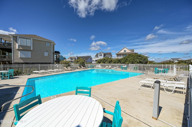 view of swimming pool featuring a patio area