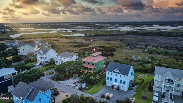 aerial view at dusk with a water view