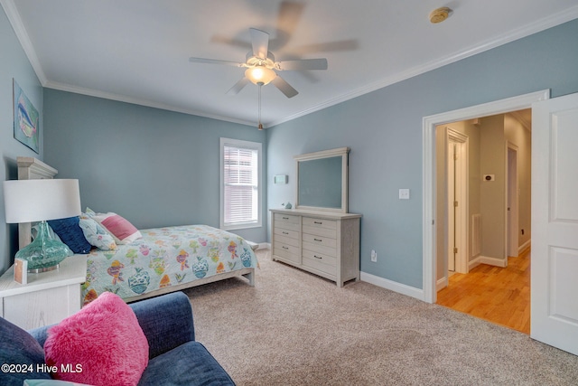 bedroom with light colored carpet, ceiling fan, and ornamental molding