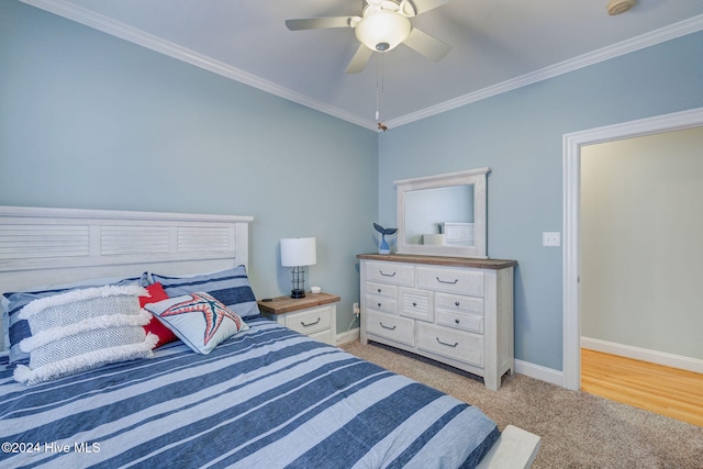 carpeted bedroom featuring ornamental molding and ceiling fan