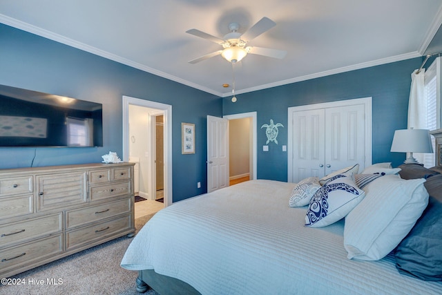 bedroom with light colored carpet, ceiling fan, crown molding, and a closet